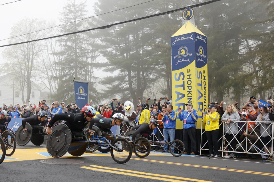 Men's wheelchair athletes Daniel Romanchuk (W1) and Marcel Hug (W2), of Switzerland, break from the starting line with others during the 127th Boston Marathon, Monday, April 17, 2023, in Hopkinton, Mass. (AP Photo/Mary Schwalm)