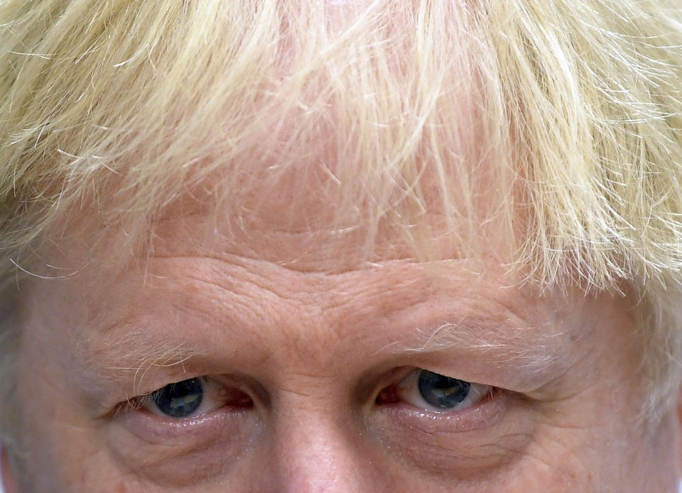 Britain's Prime Minister Boris Johnson speaks to staff in the children's ward as he visits Milton Keynes University Hospital in Milton Keynes, England, Friday Oct. 25, 2019. European Union ambassadors agreed Friday that the bloc should grant Britain’s request for another extension to the Brexit deadline but have not yet figured out how long that delay should be. (Toby Melville/Pool via AP)