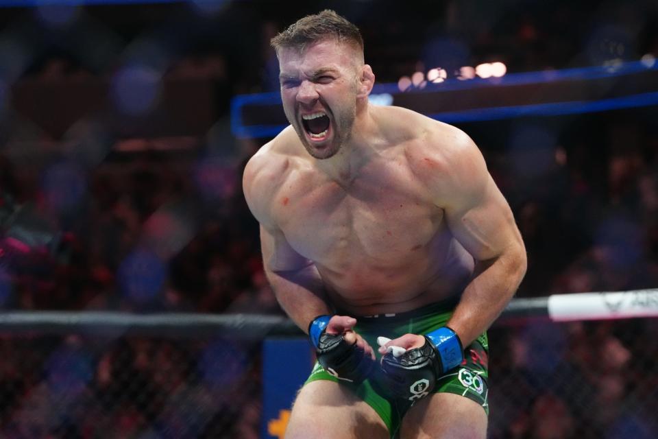 Jul 8, 2023; Las Vegas, Nevada, USA; Dricus Du Plessis (blue gloves) reacts after defeating Robert Whittaker (red gloves) during UFC 290 at T-Mobile Arena. Mandatory Credit: Stephen R. Sylvanie-USA TODAY Sports