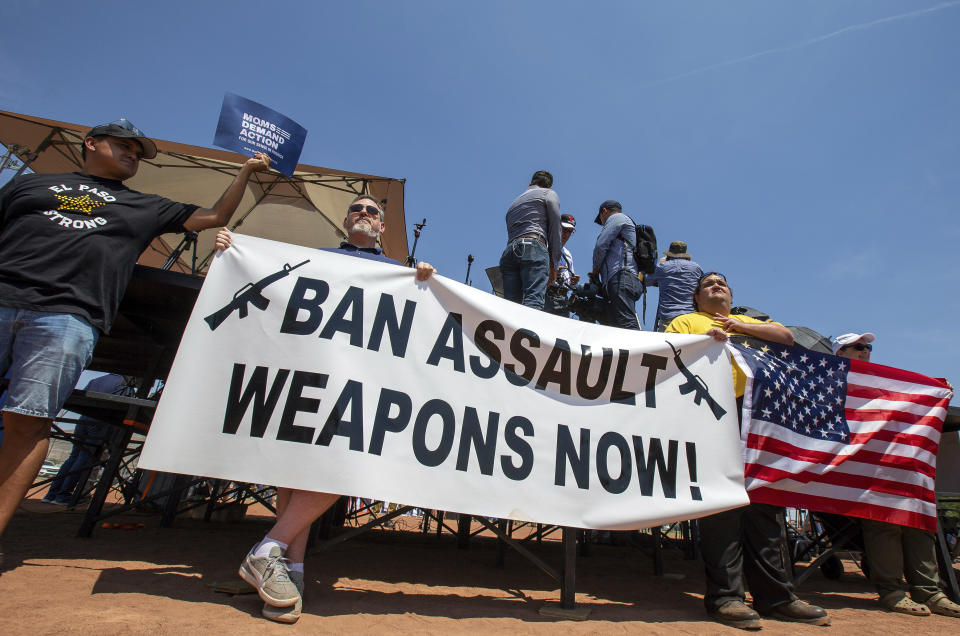 Demonstrators hold a banner to protest the visit of President Donald Trump to the border city after the Aug. 3 mass shooting in El Paso, Texas, Wednesday, Aug. 7, 2019. Trump headed to El Paso, after visiting Dayton, Ohio on Wednesday to offer a message of healing and unity, but he will be met by unusual hostility in both places by people who fault his own incendiary words as a contributing cause to the mass shootings. (AP Photo/Andres Leighton)