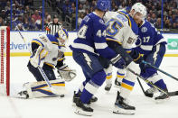 St. Louis Blues goaltender Ville Husso (35) makes a save on a shot by the Tampa Bay Lightning during the second period of an NHL hockey game Thursday, Dec. 2, 2021, in Tampa, Fla. Blues' Colton Parayko (55) keeps Lightning's Jan Rutta (44) from a rebound. (AP Photo/Chris O'Meara)