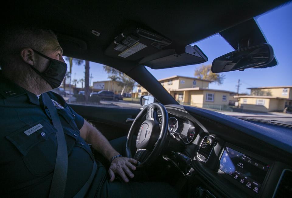 A police captain drives his patrol car at Nickerson Gardens.