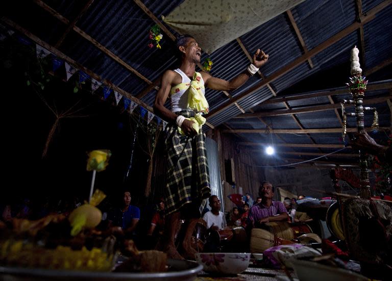 A Malaysian shaman in a trance performs "main puteri" treatment at a village in Tanah Merah, June 8, 2014