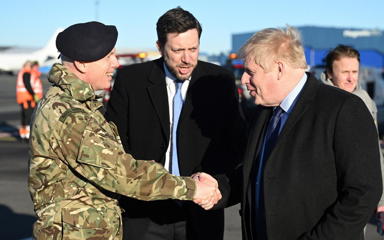 Boris Johnson in Estonia being greeted by a member of the military and Ross Allen, the British ambassador to Tallinn - Leon Neal/Getty Images