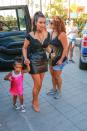 <p>A color we typically never see on Kim, North wears a hot pink slip dress with her Converses. North is clearly a major sneaker kid, whereas Kim is rarely seen without heels. (Photo: Backgrid) </p>