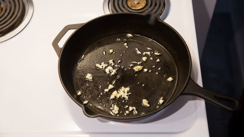 garlic cooking in iron pan 