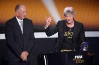 ZURICH, SWITZERLAND - JANUARY 07: Pia Sudhage, women's coach of United States receives the FIFA World Coach of Women's Football 2012 trophy by Felipe Scolari (L) at Congress House on January 7, 2013 in Zurich, Switzerland. (Photo by Christof Koepsel/Getty Images)