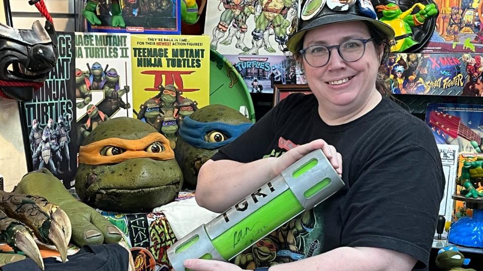 <div>Michele Ivey, a TMNT superfan, with some of her props at the TMNT Pizza Party. (Photo by Dave Herndon)</div>