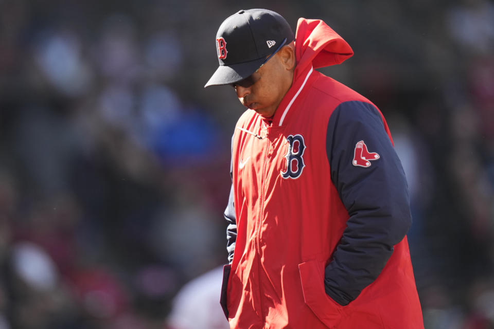 Boston Red Sox manager Alex Cora heads back to the dugout during the fourth inning of an opening day baseball game against the Baltimore Orioles, Thursday, March 30, 2023, in Boston. (AP Photo/Charles Krupa)