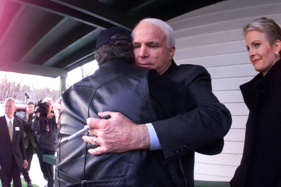 <p>McCain hugs Vietnam veteran David Wooldridge outside of a VFW during a campaign stop in Franklin, New Hampshire on January 30, 2000. McCain withdrew from the race in March 2000. Two months later he endorsed George W. Bush for president. </p>