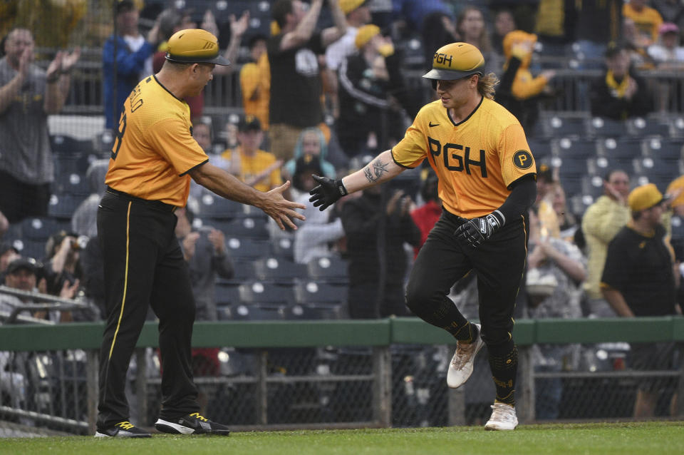 Pittsburgh Pirates' Jack Suwinski is met by third base coach Mike Rabelo while heading for home on a solo home run against the San Diego Padres during the third inning of a baseball game Tuesday, June 27, 2023, in Pittsburgh. (AP Photo/Justin Berl)
