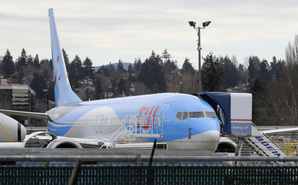 In this photo taken Monday, March 11, 2019, a Boeing 737 MAX 8 airplane being built for TUI Group sits parked at Boeing Co.'s Renton Assembly Plant in Renton, Wash. Britain, France and Germany on Tuesday joined a rapidly growing number of countries grounding the new Boeing plane involved in the Ethiopian Airlines disaster or turning it back from their airspace, while investigators in Ethiopia looked for parallels with a similar crash just five months ago. (AP Photo/Ted S. Warren)