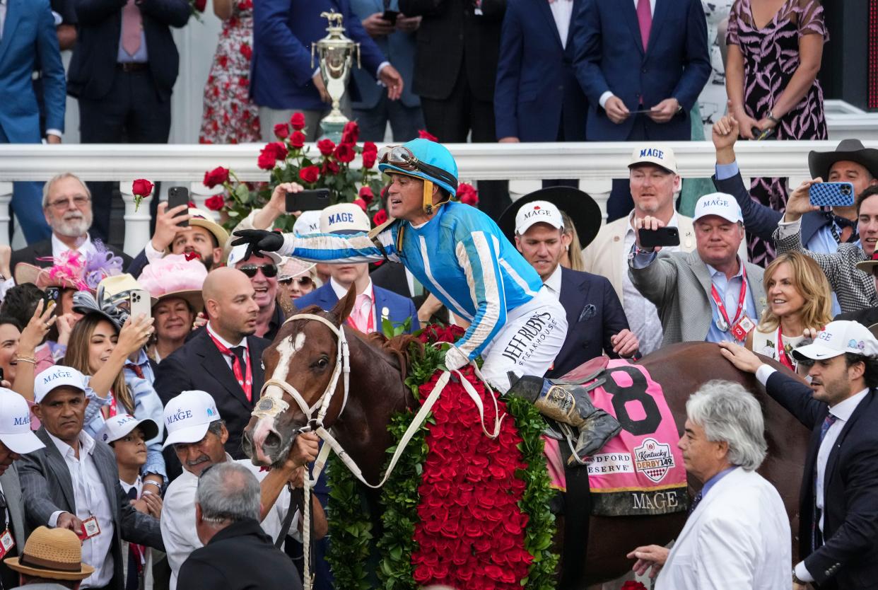 Jockey Javier Castellano aboard Mage tosses a rose to people in the Winner's Circle after the two won the 149th Kentucky Derby Saturday at Churchill Downs in Louisville, Ky. Trainer is Gustavo Delgado. May, 6, 2023.