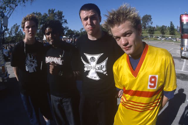 <p>Tim Mosenfelder/Getty</p> Deryck Whibley (right) with Sum 41 in June 2001