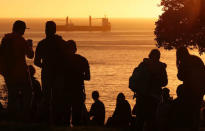 People look out towards the ocean on Cerro Castillo hill, after a mass evacuation of the entire coastline during a tsunami alert after a magnitude 7.1 earthquake hit off the coast in Vina del Mar, Chile April 24, 2017 REUTERS/Rodrigo Garrido