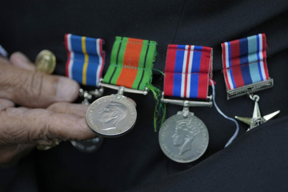 Gilbert Clarke a D-Day veteran shows his medals as he is interviewed near his home in east London, Wednesday, May 15, 2024. Clarke, now 98, is one of more than 3 million men and women from South Asia, Africa and the Caribbean who served in the British military during World War II. (AP Photo/Kirsty Wigglesworth)