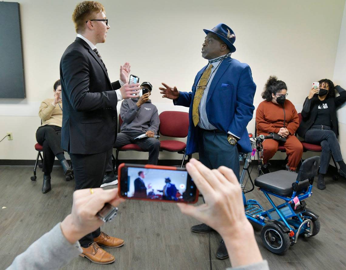 Ben Frazier, Jacksonville Northside Coalition founder, has a discussion with an aide of Gov. Ron DeSantis after Frazier refused to leave the room where the press conference with the governor was to be held in Jacksonville, Fla., on Tuesday, Jan. 4, 2022. The planned press conference with Florida Governor Ron DeSantis was relocated from the Department of Children and Families office building to the adjacent FDLE building after protesters, wanting to address the governor refused to leave the initial press conference site.