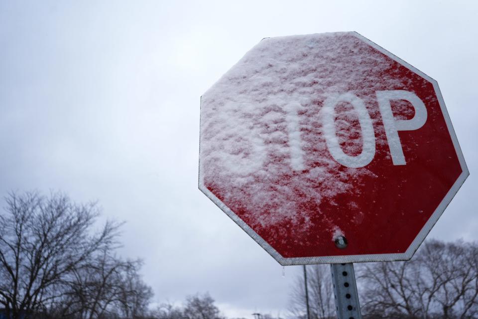 A traffic sign is covered by snow in Palatine, Ill., Saturday, Jan. 13, 2024. (AP Photo/Nam Y. Huh) ORG XMIT: OTKNH103