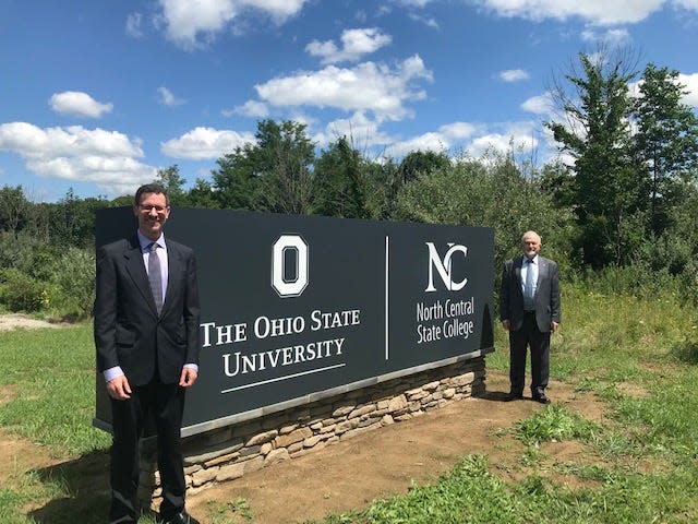 Norman Jones, left, dean and director of The Ohio State University Mansfield, and Dorey Diab, president of North Central State College, celebrate a new campus sign and entrance along Lexington-Springmill Road in this 2020 News Journal file photo.