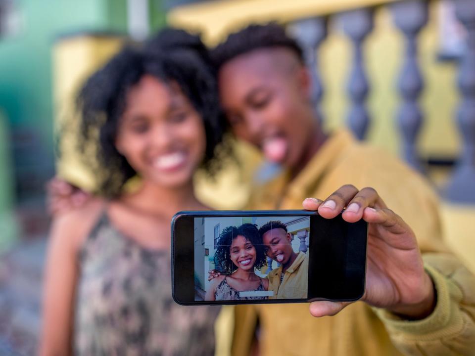 teens taking iphone selfie camera
