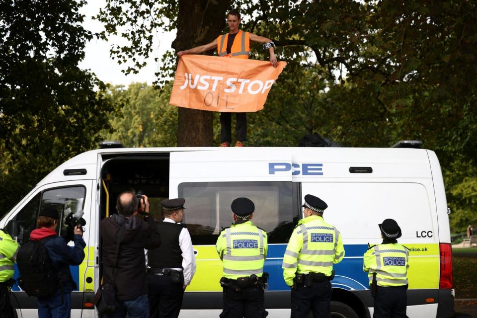 A protester standing on top of the police van outside Downing Street (REUTERS)