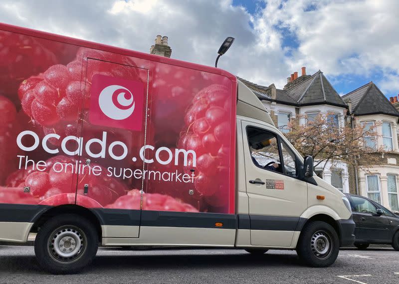 An Ocado delivery van is driven along a road in Hackney, London