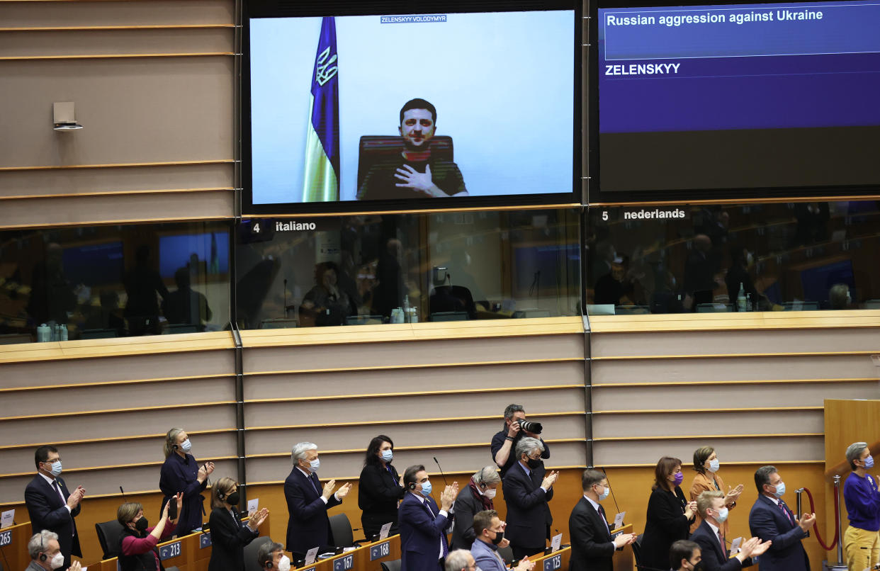 BRUSSELS, BELGIUM - MARCH 1: Ukrainian President Volodymyr Zelensky (on screen) gives a live video address during a special plenary session of the European Parliament focused on the Russian invasion of Ukraine at the EU headquarters in Brussels, on March 1, 2022. - The European Commission has opened the door for Ukraine to join the EU, but this is not for tomorrow, despite Kiev's request for a special procedure to integrate the country 