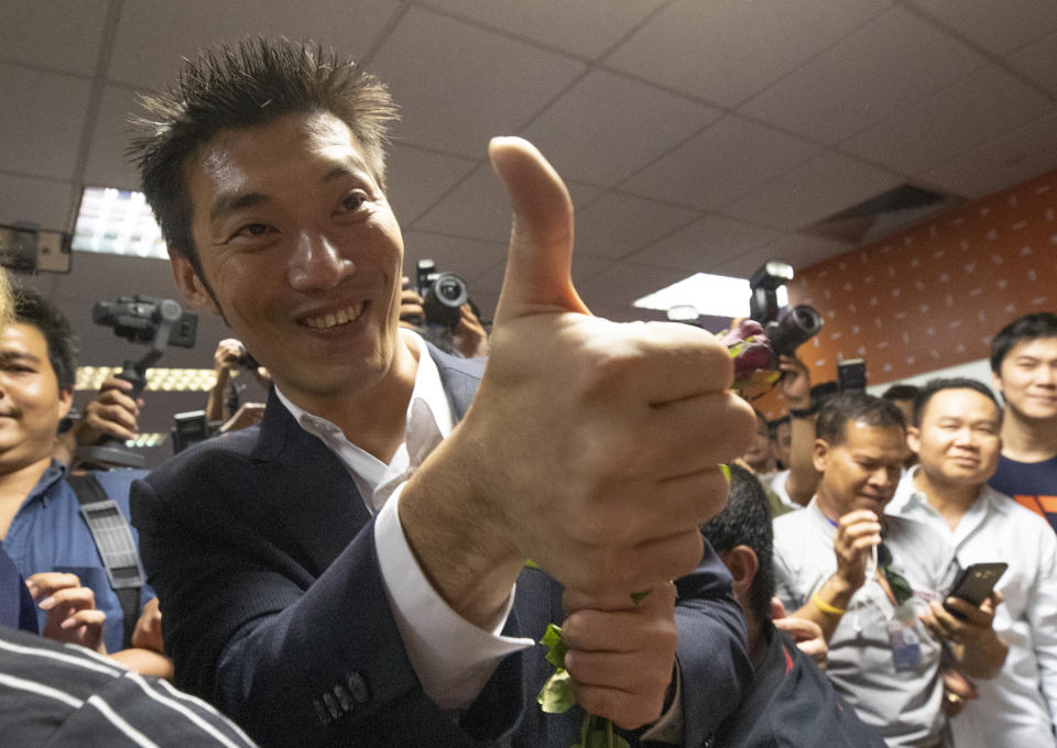 Thailand's Future Forward Party leader Thanathorn Juangroongruangkit gestures to supporters at the party's headquarters in Bangkok, Thailand, Tuesday, Jan. 21, 2020. Thailand's Constitutional Court acquitted the country's third-biggest political party of seeking the overthrow of the country's constitutional monarchy. The court ruled Tuesday that the Future Forward Party showed no intention of committing the offense, and that the complaint had not been filed according to the correct legal procedure. (AP Photo/Sakchai Lalit)