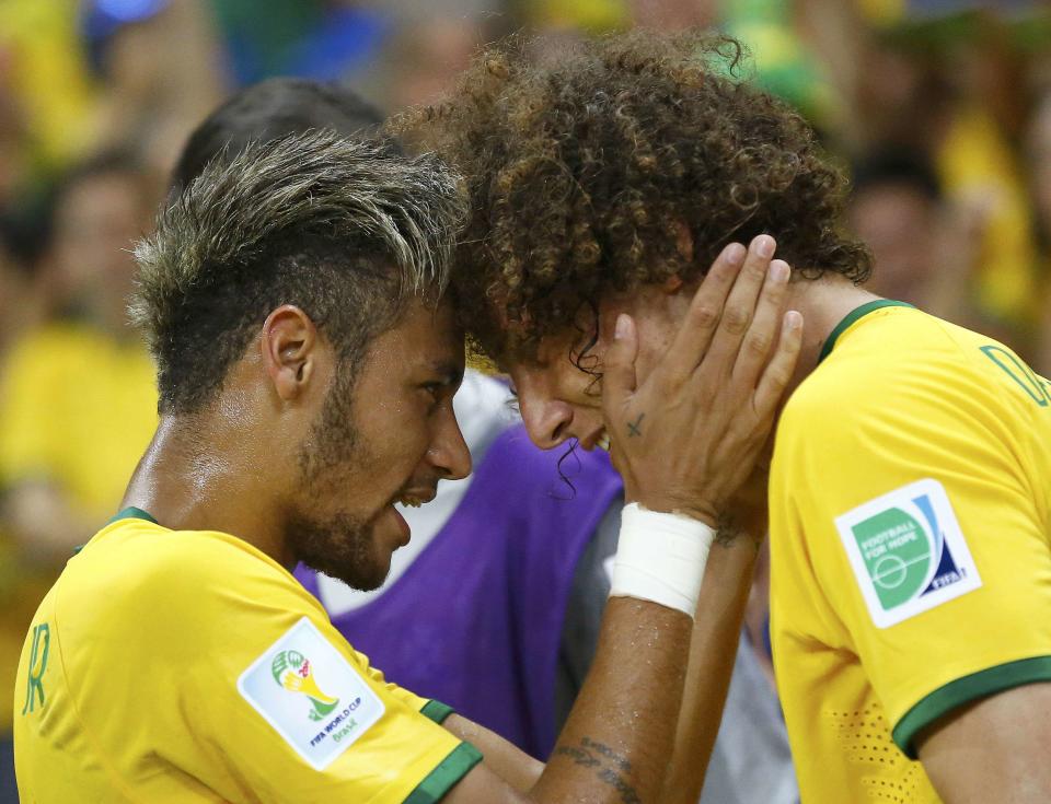 Brazil's David Luiz (R) celebrates with his teammate Neymar after scoring a goal against Colombia during the 2014 World Cup quarter-finals soccer match at the Castelao arena in Fortaleza July 4, 2014. REUTERS/Stefano Rellandini