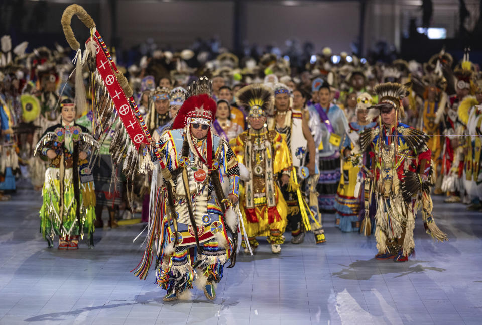 Head Man Dancer Julius Not Afraid of Rocky Boy, Montana leads over a thousand dancers in the arena for the grand entry at the 40th anniversary of the Gathering of Nations Pow Wow in Albuquerque, N.M., Friday, April 28, 2023. The annual Gathering of Nations kicked off Friday with a colorful procession of Native American and Indigenous dancers from around the world moving to the beat of traditional drums as they fill an arena at the New Mexico state fairgrounds. (AP Photo/Roberto E. Rosales)