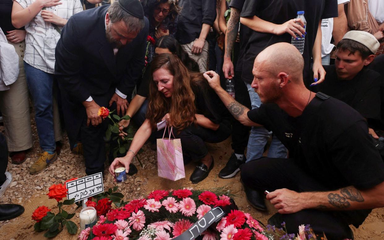 Shani Louk's mother at her grave during the funeral in Srigim, in Israel