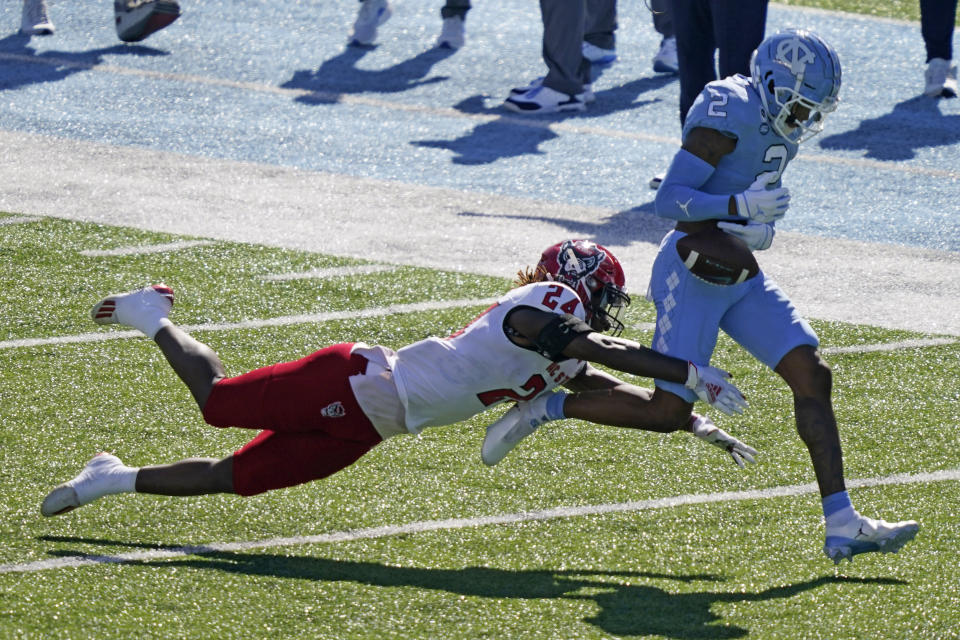 North Carolina wide receiver Dyami Brown (2) loses the ball while North Carolina State cornerback Malik Dunlap (24) defends during the first half of an NCAA college football game in Chapel Hill, N.C., Saturday, Oct. 24, 2020. (AP Photo/Gerry Broome)