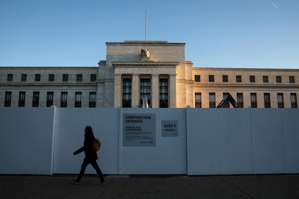 A pedestrian walks past the Federal Reserve Headquarters on March 21, 2023, in Washington, D.C. The Federal Open Market Committee met Tuesday and Wednesday to decide on a possible interest rate hike in the middle of ongoing banking turmoil.