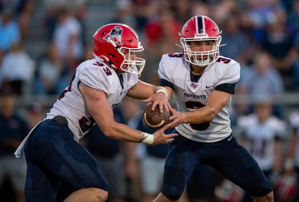Heritage Hills' Braydon Durham (33) receives the handoff from Jett Goldsberry (3) as the Heritage Hills Patriots play the Boonville Pioneers Friday, Sept. 1, 2023.