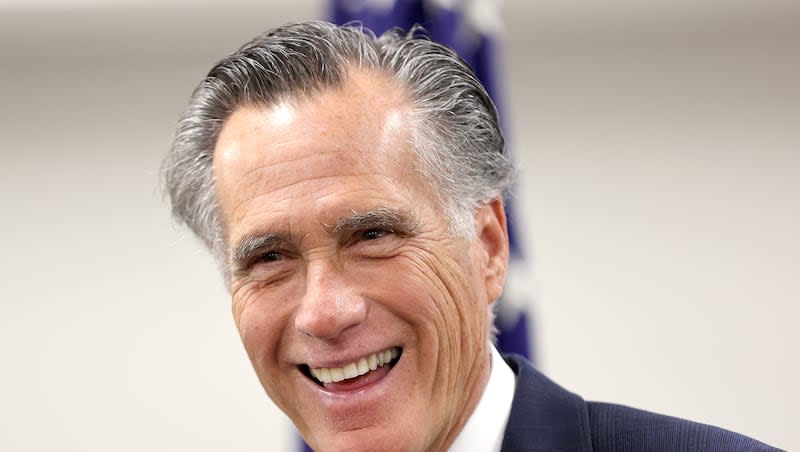 Sen. Mitt Romney, R-Utah, speaks to members of the media while visiting the State Department’s Salt Lake City Passport Fair at the Bennett Federal Building in Salt Lake City on Friday, Feb. 16, 2024. A Washington Post op-ed and Sen. John Fetterman said Romney should lead Harvard.