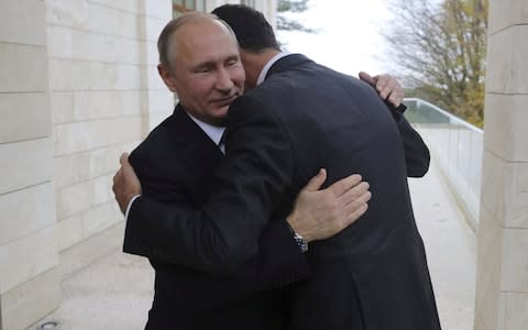 Russian President Vladimir Putin (L) welcomes Syrian President Bashar al-Assad during a meeting in the Black Sea resort of Sochi, Russia November 20, 2017 - Credit: Reuters