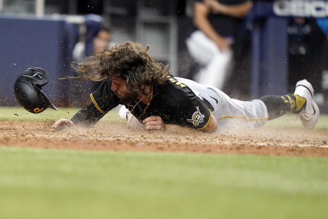 Pittsburgh Pirates' Yoshi Tsutsugo follows through on a line out