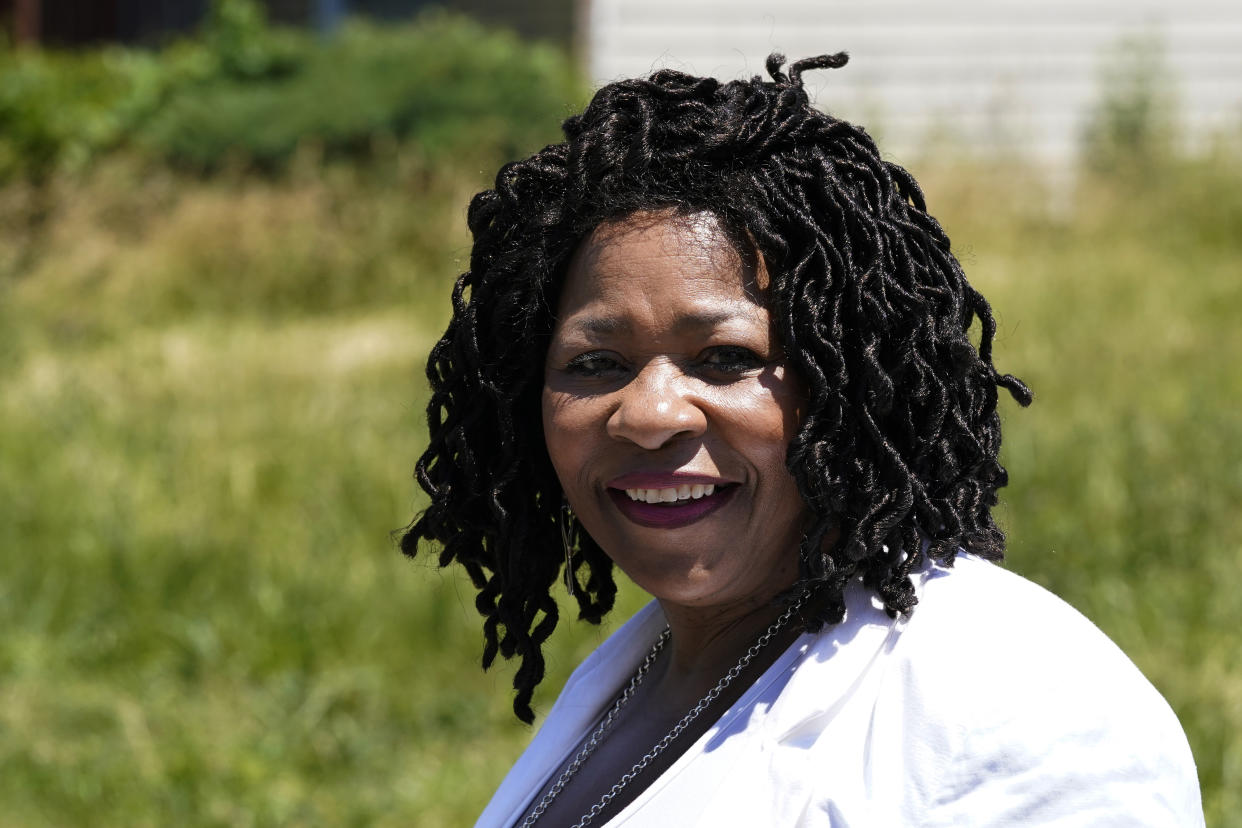 Donele Wilkins, founder of Green Door Initiative, a group that does environmental workforce development, stands in the field next to her childhood home where her company is developing a solar community hub, Tuesday, June 28, 2022, in Detroit. Fourteen smaller environmental justice organizations from around the United States, including Green Door Initiative, have begun to receive money under the Justice40 initiative to improve the environment in disadvantaged communities and help them prepare for climate change. (AP Photo/Carlos Osorio)