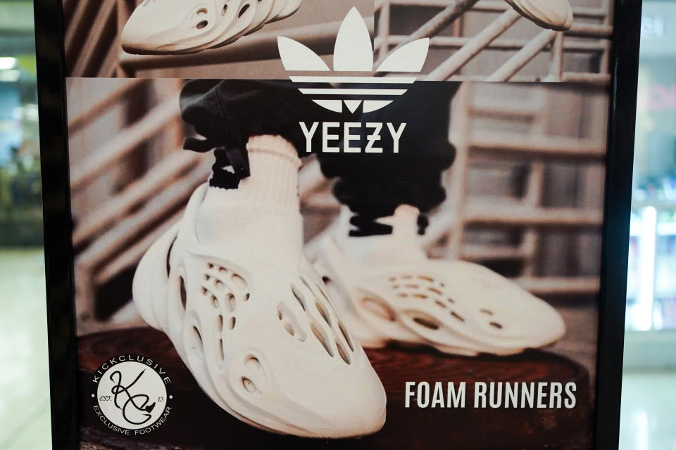 FILE - A sign advertises Yeezy shoes made by Adidas at Kickclusive, a sneaker resale store, in Paramus, N.J., Oct. 25, 2022. Adidas forecast it may have to write off the remaining 300 million euros ($320 million) worth of Yeezy shoes left unsold after it cut ties with rapper Ye, formerly known as Kanye West. The company on Wednesday, Nov. 8, 2023 said it will decide in the coming weeks whether or not to do a third release of the shoes next year to generate more donations to groups fighting anti semitism.(AP Photo/Seth Wenig, File)