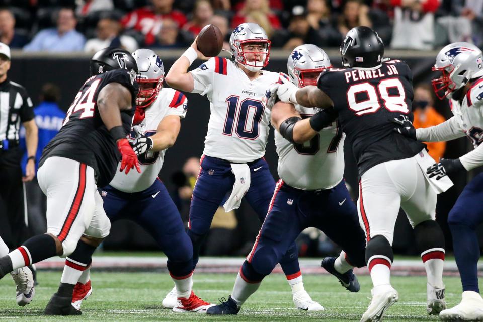 Patriots quarterback Mac Jones throws through traffice against the Falcons last month.