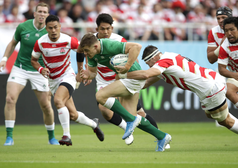 Ireland's Garry Ringrose is tackled by Japan's Luke Thompson during the Rugby World Cup Pool A game at Shizuoka Stadium Ecopa between Japan and Ireland in Shizuoka, Japan, Saturday, Sept. 28, 2019. (AP Photo/Jae Hong)