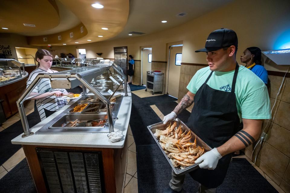 Crab legs are the main attraction, all you can eat, at Captain Jack's Family Buffet in Panama City Beach. Captain Jack's has been family owned and operated on the beach since 2000. Employee Gasbar Williams, pictured, restocks the buffet with a fresh tray of crab legs.