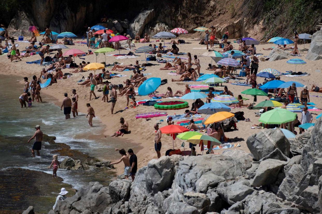 People enjoy a day out at the beach in Platja DAro near Girona, yesterday: AFP via Getty Images