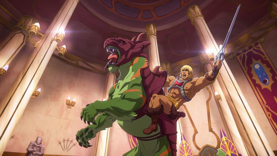 In a CG animated still from Masters of the Universe: Revelation, He-Man wears a silver chest plate with a red "H" in the center, a golden armored belt and golden wrist plates. He raises his silver sword atop Battle Cat, a green tiger with orange stripes and maroon armor on his hind legs. The two are in the center of a throne room.