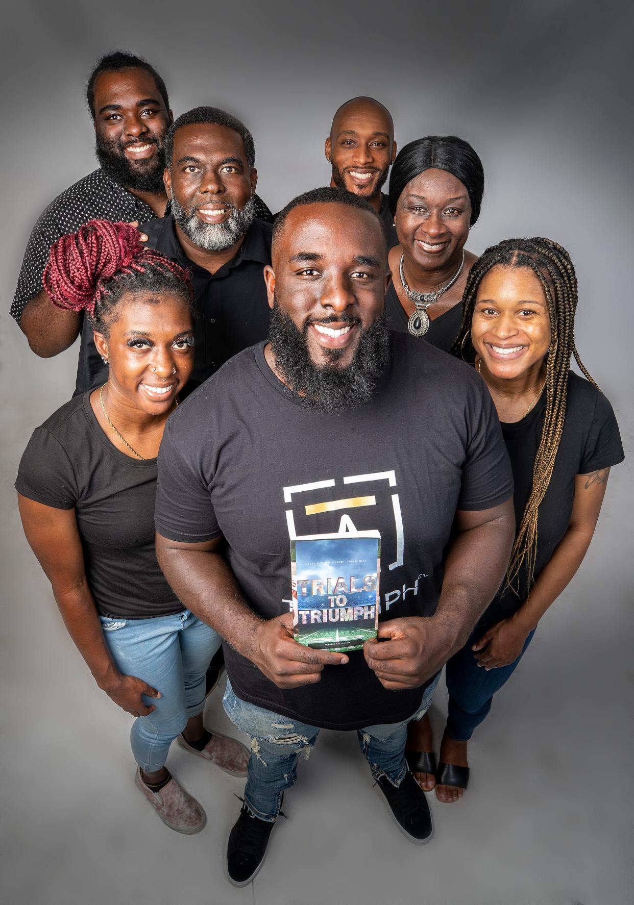 Freddie Stevenson , center with his family l-r sister Tekaysha Stevenson , brother Tarvea Stevenson , father Terriss Stevenson , brother Cornelius  Toney , mother Sylvia Stevenson and sister Cappy Toney In Lakeland Fl. Wednesday September21,2022. Freddie Stevenson, former football player from Bartow, FSU, NFL, wrote a book called Trials To Triumph that's turned into a documentary about overcoming adversity. Ernst Peters/.The Ledger
