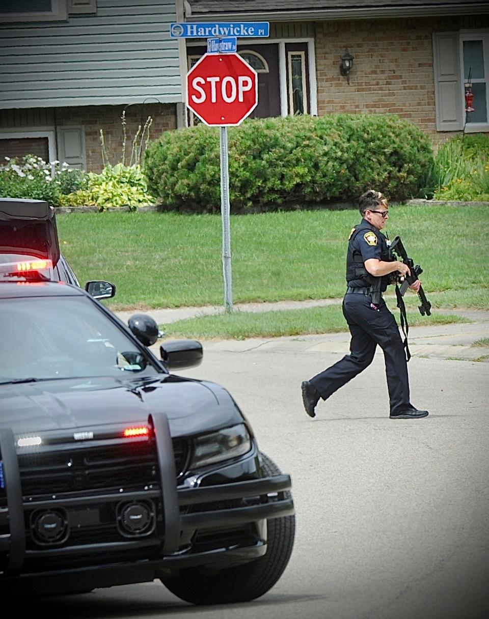 Police investigate a shooting Friday, Aug. 5, 2022, in Butler Township, Ohio.  Authorities say four people were shot to death in the Ohio suburb and a man considered armed and dangerous is being sought.