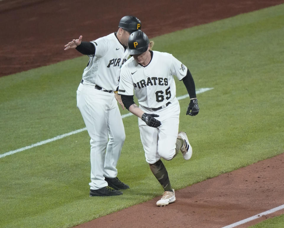 Pittsburgh Pirates' Jack Suwinski, right, is greeted by third base coach Mike Rabelo as he rounds the bases after hitting a solo home run to tie a baseball game against the St. Louis Cardinals during the eighth inning Monday, Oct. 3, 2022, in Pittsburgh. (AP Photo/Keith Srakocic)