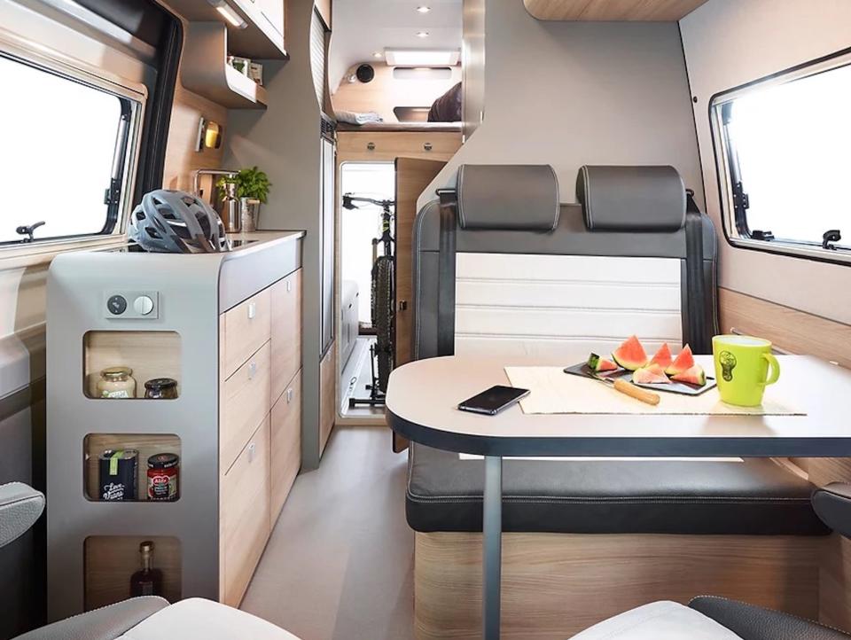 A living room near a kitchen in the camper van.
