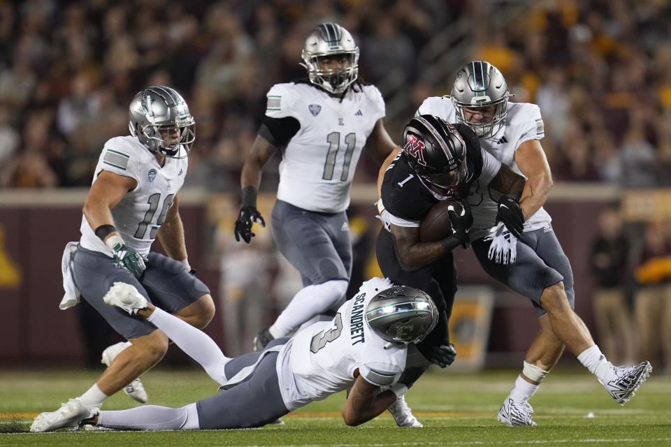 Minnesota running back Darius Taylor is tackled by Eastern Michigan defensive back Quentavius Scandrett (3) and linebacker Zach Mowchan, right, during the second half of an NCAA college football game Saturday, Sept. 9, 2023, in Minneapolis. (AP Photo/Abbie Parr)