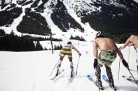 Skiers leave the starting line during the Bikini & Board Shorts Downhill at Crystal Mountain, a ski resort near Enumclaw, Washington April 19, 2014. Skiers and snowboarders competed for a chance to win one of four season's passes. REUTERS/David Ryder (UNITED STATES - Tags: SPORT SOCIETY)